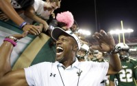 FILE - In this Oct. 5, 2015, file photo, South Florida coach Willie Taggart celebrates with fans after South Florida defeated Cincinnati 26-20 in an NCAA college football game in Tampa, Fla. After hitting rock bottom at Maryland last year, USF went 7-3, played like one of the best teams in the country outside the Power Five and Taggart went from a coach with an uncertain future to one with a three-year contract extension. (AP Photo/Chris O'Meara, File)