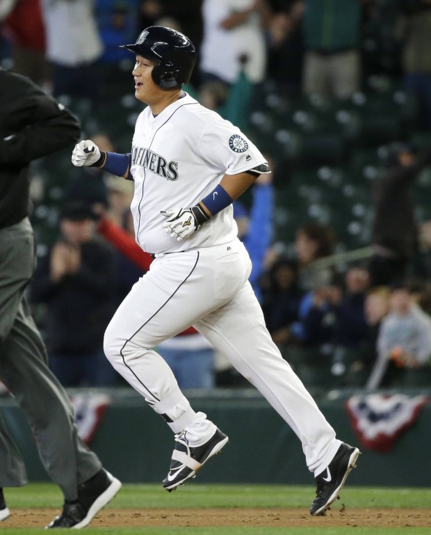 Seattle Mariners' Dae-Ho Lee rounds the bases after he hit a walk-off two-run home run in the tenth inning of a baseball game against the Texas Rangers, Wednesday, April 13, 2016, in Seattle. The Mariners beat the Rangers 4-2 in ten innings. (AP Photo/Ted S. Warren)