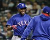 Texas Rangers' Elvis Andrus, left, is greeted at the dugout after he scored a run in the eighth inning of a baseball game against the Seattle Mariners, Monday, April 11, 2016, in Seattle. The Rangers beat the Mariners 7-3. (AP Photo/Ted S. Warren)
