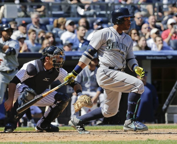Seattle Mariners' Robinson Cano follows through on an hits an RBI double during the fifth inning of a baseball game as New York Yankees catcher Austin Romine, left, watches Saturday, April 16, 2016, in New York. (AP Photo/Frank Franklin II)