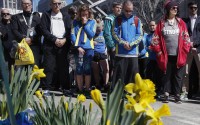 People observe a moment of silence at the site where the first of two bombs detonated at the Boston Marathon finish line on the third anniversary of the bombings, Friday, April 15, 2016, in Boston. (AP Photo/Michael Dwyer)