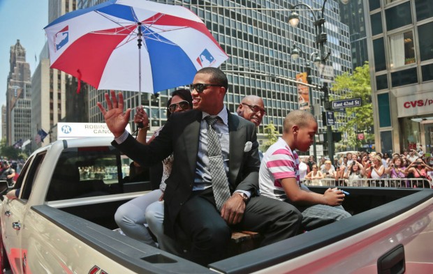 FILE - In this July 16, 2013, file photo, then-New York Yankees second baseman Robinson Cano waves to fans during a parade along 42nd Street in New York before the baseball All-Star Game. The Seattle Mariners All-Star second baseman is supremely fashion-conscious, and he talks with joy about the collection in his massive closet. (AP Photo/Bebeto Matthews, File)