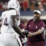 Texas  A&M offensive lineman Germain Ifedi (74) is greeted by coach Kevin Sumlin as he jogs off the field during the first half of an NCAA college football game against Arkansas on Saturday, Sept. 26, 2015, in Arlington, Texas. (AP Photo/Tony Gutierrez)