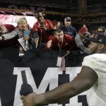 Alabama's Jarran Reed celebrates with fans after the NCAA college football playoff championship game against Clemson Monday, Jan. 11, 2016, in Glendale, Ariz. Alabama won 45-40. (AP Photo/Chris Carlson)