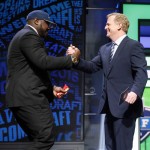 Alabama's Jarran Reed celebrates with NFL Commissioner Roger Goodell after being selected by the Seattle Seahawks as the 49th pick in the second round of the 2016 NFL football draft, Friday, April 29, 2016, in Chicago. (AP Photo/Charles Rex Arbogast)
