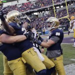 Notre Dame wide receiver C.J. Prosise, center, is picked up by center Nick Martin, left, as running back Cam McDaniel, right, celebrates with them after Prosise scored a touchdown on a 50-yard run against LSU in the second half of the Music City Bowl NCAA college football game Tuesday, Dec. 30, 2014, in Nashville, Tenn. Notre Dame won 31-28. (AP Photo/Mark Humphrey)