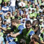 Seattle Sounders' Jordan Morris, left, Zach Scott, center, and Columbus Crew's Kei Kamara, right, go for a header in the second half of an MLS soccer match, Saturday, April 30, 2016, in Seattle. (AP Photo/Ted S. Warren)