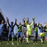 Seattle Sounders players, including goalkeeper Stefan Frei, center, celebrate after the Sounders beat the Columbus Crew 1-0 in an MLS soccer match, Saturday, April 30, 2016, in Seattle. (AP Photo/Ted S. Warren)