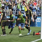 With Columbus Crew goalkeeper Steve Clark sitting near the goal line at right, Seattle Sounders' Nelson Valdez, third from right, and Joevin Jones, third from left, run past Columbus Crew's Michael Parkhurst, second from left, and Tyson Wahl, second from right, as they celebrate a goal scored by Seattle Sounders' Jordan Morris, not shown, in the second half of an MLS soccer match, Saturday, April 30, 2016, in Seattle. The Sounders beat the Crew 1-0. (AP Photo/Ted S. Warren)