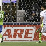 Seattle Sounders' Jordan Morris, left, kicks a goal as Philadelphia Union's Richie Marquez (16) and goalkeeper Andre Blake (obscured) watch during the second half of an MLS soccer match, Saturday, April 16, 2016, in Seattle. The goal was Morris' first career MLS goal, and the Sounders defeated the Union 2-1. (AP Photo/Ted S. Warren)