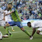 Seattle Sounders' Clint Dempsey, center, drives past Philadelphia Union's Richie Marquez, left, and Warren Creavalle, right, during the first half of an MLS soccer match, Saturday, April 16, 2016, in Seattle. (AP Photo/Ted S. Warren)