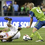 Philadelphia Union midfielder Tranquillo Barnetta, left, goes down as Seattle Sounders midfielder Osvaldo Alonso moves the ball during the second half of an MLS soccer match, Saturday, April 16, 2016, in Seattle. The Sounders won 2-1. (AP Photo/Ted S. Warren)