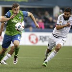Seattle Sounders' Jordan Morris, left, drives with the ball as Philadelphia Union's Richie Marquez, right, pursues during the first half of an MLS soccer match, Saturday, April 16, 2016, in Seattle. (AP Photo/Ted S. Warren)