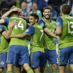 Seattle Sounders' Chad Marshall (14) is congratulated by teammates after he scored a goal against the Philadelphia Union during the first half of an MLS soccer match Saturday, April 16, 2016, in Seattle. (AP Photo/Ted S. Warren)