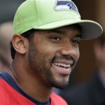 Seattle Seahawks quarterback Russell Wilson smiles as he speaks with media members after NFL football practice Thursday, May 26, 2016, in Renton, Wash. (AP Photo/Elaine Thompson)
