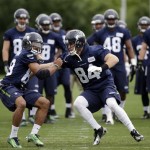 Seattle Seahawks' Doug Baldwin, left, and Cooper Helfet run through a drill at NFL football practice Thursday, May 26, 2016, in Renton, Wash. (AP Photo/Elaine Thompson)
