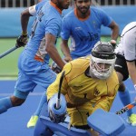 
              Germany's goalkeeper Nicolas Jacobi, foreground, saves the ball against India's Sunil Sowmarpet, center background, during a men's field hockey match at 2016 Summer Olympics in Rio de Janeiro, Brazil, Monday, Aug. 8, 2016. (AP Photo/Hussein Malla)
            