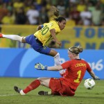 
              Brazil's Marta, left, leaps over Sweden goalkeeper Hedvig Lindahl as she attempts a shot on goal during a group E match of the women's Olympic football tournament between Sweden and Brazil at the Rio Olympic Stadium in Rio De Janeiro, Brazil, Saturday, Aug. 6, 2016. Brazil won the game 5-1. (AP Photo/Leo Correa)
            
