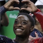 
              United States' Simone Biles forms a heart shape with her hands at the end of the artistic gymnastics women's qualification at the 2016 Summer Olympics in Rio de Janeiro, Brazil, Sunday, Aug. 7, 2016. (AP Photo/Rebecca Blackwell)
            