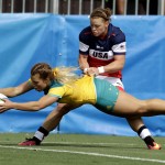 
              Australia's Emma Tonegato, front, scores a try as USA's Alev Kelter, tries to defend during the women's rugby sevens match at the Summer Olympics in Rio de Janeiro, Brazil, Sunday, Aug. 7, 2016. (AP Photo/Themba Hadebe)
            