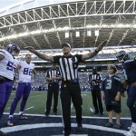 Referee Ed Hochuli, center, speaks during the coin flip at CenturyLink Field before a preseason NFL football game between the Seattle Seahawks and the Minnesota Vikings, Thursday, Aug. 18, 2016, in Seattle. (AP Photo/Elaine Thompson)