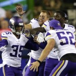 Minnesota Vikings cornerback Marcus Sherels, left, is greeted by teammates, including outside linebacker Chad Greenway (52). after Sherels intercepted a pass from Seattle Seahawks quarterback Trevone Boykin to score the go-ahead touchdown in a preseason NFL football game, Thursday, Aug. 18, 2016, in Seattle. The Vikings won 18-11. (AP Photo/John Froschauer)