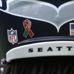 
              Seattle Seahawks cornerback Richard Sherman wears a ribbon decal on his helmet that reads "9/11" in observance of the 15th anniversary of the Sept. 11, 2001 terrorist attacks, before NFL football game against the Miami Dolphins, Sunday, Sept. 11, 2016, in Seattle. (AP Photo/Elaine Thompson)
            
