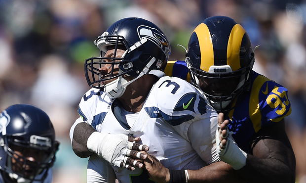 Russell Wilson's ankle injury could be preventing the Seahawks from calling read option plays. (AP)...