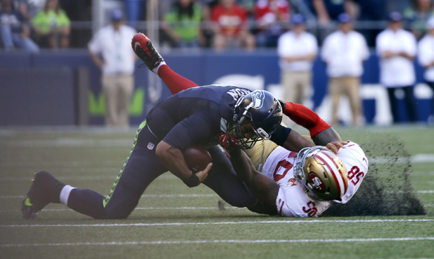 Russell Wilson was pulled down awkwardly by San Francisco's Eli Harold in the third quarter Sunday....