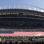A U.S. flag fills the field at CenturyLink Field during the singing of the national anthem before an NFL football game between the Seattle Seahawks and the Miami Dolphins, Sunday, Sept. 11, 2016, in Seattle. (AP Photo/Ted S. Warren)
