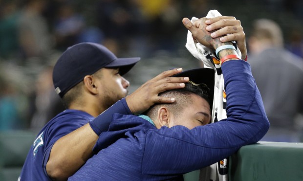 Franklin Gutierrez consoles Felix Hernandez after the A's defeated the Mariners 9-8 Saturday. (AP)...