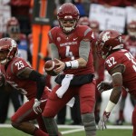 Washington State quarterback Luke Falk (4) hands the ball off to running back James Williams (32) in the first half of an NCAA college football game, Friday, Nov. 25, 2016, in Pullman, Wash. (AP Photo/Ted S. Warren)
