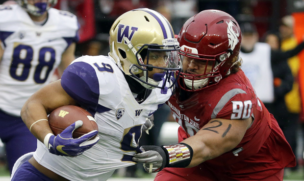 Myles Gaskin and the Huskies rose to No. 4 in the AP poll after beating WSU in the Apple Cup. (AP)...