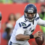 Seattle Seahawks quarterback Russell Wilson (3) scrambles away from Tampa Bay Buccaneers defensive tackle Gerald McCoy (93) during the first quarter of an NFL football game Sunday, Nov. 27, 2016, in Tampa, Fla. (AP Photo/Jason Behnken)