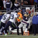 New England Patriots wide receiver Julian Edelman (11) catches a pass in front of Seattle Seahawks defenders DeShawn Shead (35) and Earl Thomas (29) during the second half of an NFL football game, Sunday, Nov. 13, 2016, in Foxborough, Mass. (AP Photo/Charles Krupa)