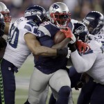 Seattle Seahawks defenders K.J. Wright (50) and Ahtyba Rubin (77) wrap up New England Patriots running back LeGarrette Blount (29) during the second half of an NFL football game, Sunday, Nov. 13, 2016, in Foxborough, Mass. (AP Photo/Charles Krupa)