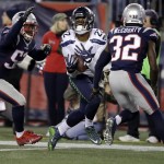 Seattle Seahawks running back C.J. Prosise (22) catches a pass between New England Patriots defenders Elandon Roberts, left, and Devin McCourty (32) during the second half of an NFL football game, Sunday, Nov. 13, 2016, in Foxborough, Mass. (AP Photo/Charles Krupa)