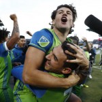Seattle Sounders forward Nelson Haedo Valdez, top, hugs midfielder Cristian Roldan after defeating the Colorado Rapids in the second leg of the MLS Western Conference soccer finals game Sunday, Nov. 27, 2016, in Commerce City, Colo.  (AP Photo/David Zalubowski)