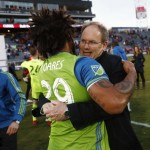 Seattle Sounders defender Roman Torres, front, hugs head coach Brian Schmetzer after defeating the Colorado Rapids in the second leg of the MLS Western Conference soccer finals Sunday, Nov. 27, 2016, in Commerce City, Colo. (AP Photo/David Zalubowski)
