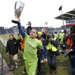 Seattle Sounders midfielder Osvaldo Alonso holds up the trophy after defeating Colorado in the second leg of the MLS Western Conference soccer finals Sunday, Nov. 27, 2016, in Commerce City, Colo. (AP Photo/David Zalubowski)