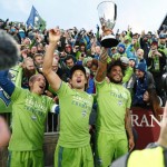 From left to right, Seattle Sounders midfielder Osvaldo Alonso, forward Nelson Haedo Valdez and defender Roman Torres celebrate with fans after defeating Colorado in the second leg of the MLS Western Conference soccer finals Sunday, Nov. 27, 2016, in Commerce City, Colo. (AP Photo/David Zalubowski)