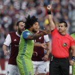 Seattle Sounders defender Roman Torres, left, argues after he was issued a yellow card while facing the Colorado Rapids in the first half of the second leg of an MLS Western Conference soccer finals Sunday, Nov. 27, 2016, in Commerce City, Colo. (AP Photo/David Zalubowski)