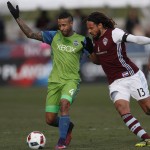 Seattle Sounders defender Tyrone Mears, left, fights for control of the ball with Colorado Rapids midfielder Jermaine Jones in the first half of the second leg of an MLS Western Conference soccer finals Sunday, Nov. 27, 2016, in Commerce City, Colo. (AP Photo/David Zalubowski)