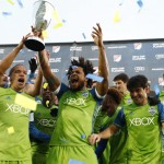 From left to right, Seattle Sounders midfielder Osvaldo Alonso, defender Roman Torres and midfielder Nicolas Lodeiro celebrate with teammates after being awarded the trophy for defeating Colorado in the second half of the second leg of the MLS Western Conference soccer finals Sunday, Nov. 27, 2016, in Commerce City, Colo. (AP Photo/David Zalubowski)