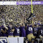 Washington players celebrate with the trophy after a 41-10 win over Colorado in the Pac-12 Conference championship NCAA college football game Friday, Dec. 2, 2016, in Santa Clara, Calif. (AP Photo/Marcio Jose Sanchez)