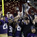 Washington coach Chris Petersen holds the trophy after Washington's 41-10 win over Colorado in the Pac-12 Conference championship NCAA college football game Friday, Dec. 2, 2016, in Santa Clara, Calif. (AP Photo/Marcio Jose Sanchez)