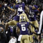 Washington wide receiver John Ross (1) celebrates his touchdown catch with teammates, including Sidney Jones (26) and Chico McClatcher (6), during the second half of the Pac-12 Conference championship NCAA college football game against Colorado Friday, Dec. 2, 2016, in Santa Clara, Calif. (AP Photo/Marcio Jose Sanchez)