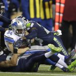 Detroit Lions fullback Zach Zenner (34) is tackled by Seattle Seahawks cornerback Richard Sherman, lower left, and free safety Steven Terrell, right, in the first half of an NFL football NFC wild card playoff game, Saturday, Jan. 7, 2017, in Seattle. (AP Photo/Stephen Brashear)