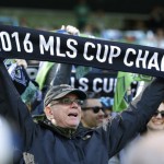 A Seattle Sounders supporter holds up a an MLS Cup championship scarf before an MLS soccer match against the New York Red Bulls, Sunday, March 19, 2017, in Seattle. (AP Photo/Ted S. Warren)
