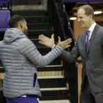 Mike Hopkins, right Washington's new head NCAA college basketball coach, talks with guard David Crisp, left, Wednesday, March 22, 2017, in Seattle. Hopkins, a longtime Syracuse assistant coach, replaces Lorenzo Romar. (AP Photo/Ted S. Warren)